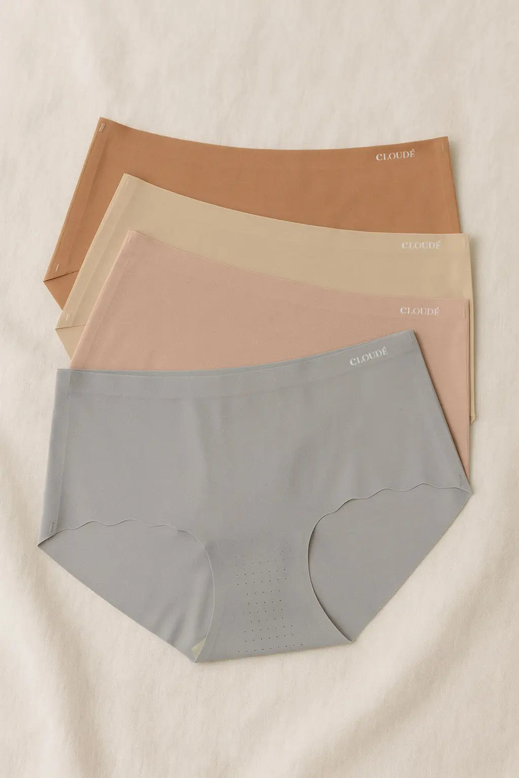 Flat lay of Muted Muse seamless women’s underwear set in gray, beige, nude pink, and peach, made from breathable nylon with mugwort-infused modal lining for all-day comfort.