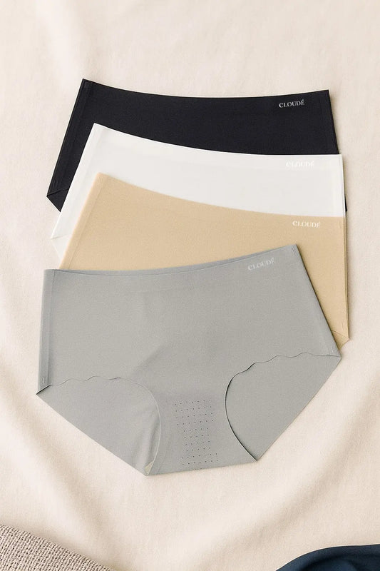 Flat lay of 4-piece Core Neutral seamless women’s underwear set in black, white, gray, and beige – breathable nylon with mugwort-infused modal lining for invisible, all-day comfort.